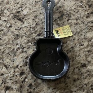 The large cast-iron skillet, Dolly Parton mini cast-iron skillet guitar pan